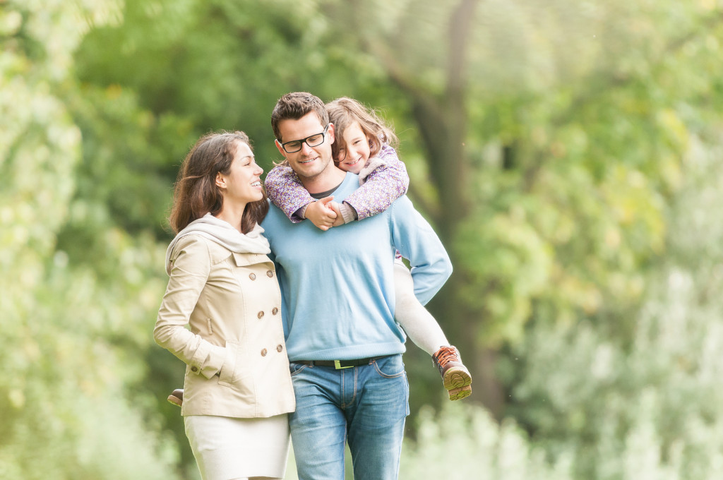 Happy family of three having fun outdoor.